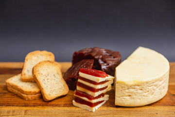 Sweet, romeo and juliet, Cheese with guava on wooden board and black background
