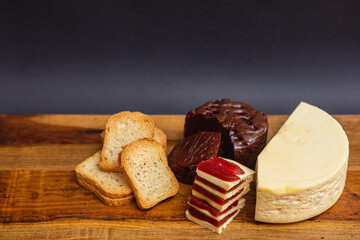 Sweet, romeo and juliet, Cheese with guava on wooden board and black background,