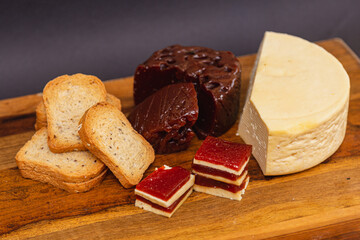 Sweet, romeo and juliet, Cheese with guava on wooden board and black background, close