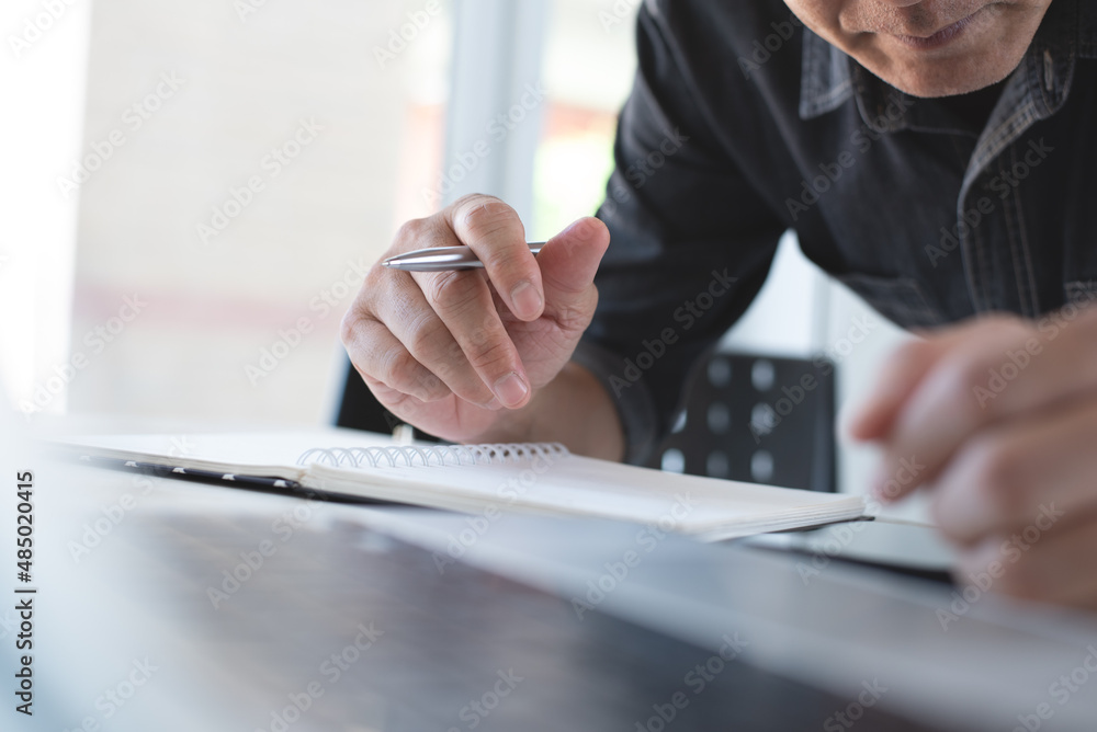 Aufkleber close up of asian casual business man using laptop computer and using mobile phone, searching inform