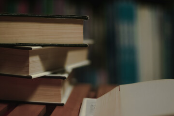 Stack of books on the library. World book day. Knowledge, education and learning concept. Selective focus.