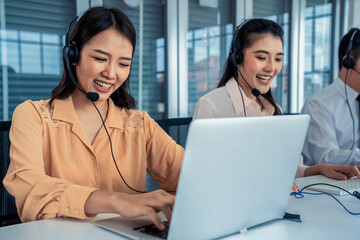 Business people wearing headset working actively in office . Call center, telemarketing, customer...