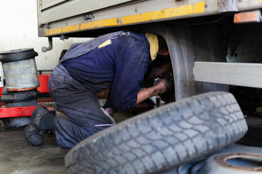 Mechanic repair truck in the service station.