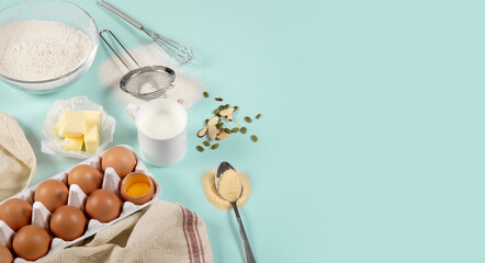 Composition of ingredients for baking on colored paper (eggs, flour, butter, nuts, milk and tools)