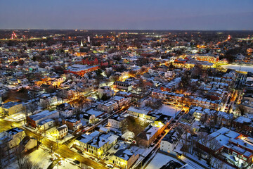 Aerial View of Riverfront Town at Night with Snow
