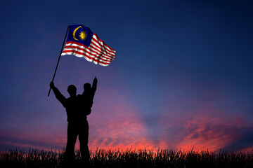 Father and son hold the flag of Malaysia