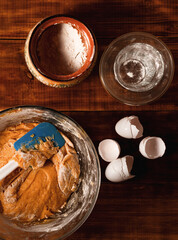 Bakery Ingredients and Kitchen Utensils on Wooden Rural Kitchen Table for Baking Thematic Background.