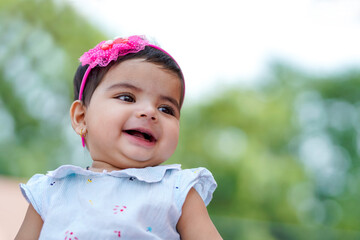 Indian baby girl child playing and giving smile