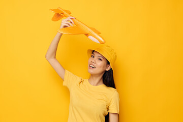 Portrait Asian beautiful young woman cheerful woman with an airplane in the hands of fun isolated background unaltered