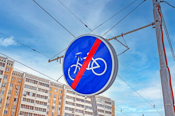 A sign prohibiting cycling on the background of tram trolls on a winter day