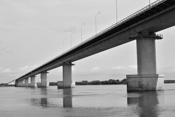 View of the bridge over the river. Black and white photo.