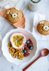 Delicious homemade meal. Caramelised Banana Muesli Bowl with Almond Milk, Passion Fruit, Pecans, Blueberries, Goji Berry and Cornbread. Strictly for healthy lifestyle, full of goodness and nutrition.