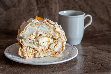 Delicate and airy meringue cake on a plate on the table.