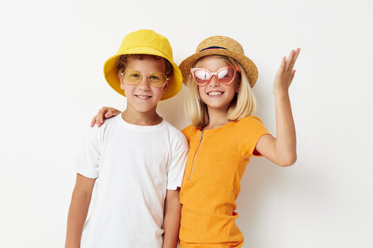 funny boy and girl wearing hats posing fashion light background
