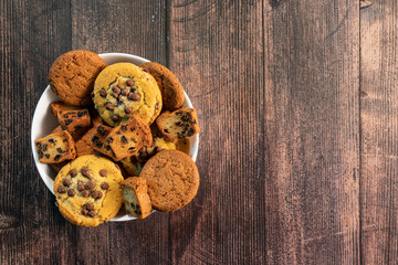 Homemade cookies with chocolate, nuts and coffee beans on a  wooden backgroundwith a background blur.