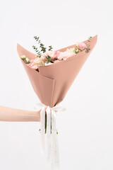 Close up cropped photo of female hold in hands bouquet of flowers isolated on white wall background. Copy space advertising mock up. Valentine's Day Women's Day birthday holiday party concept