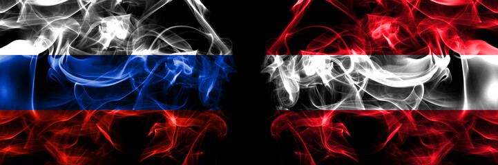 Russia, Russian vs Austria, Austrian flags. Smoke flag placed side by side isolated on black background