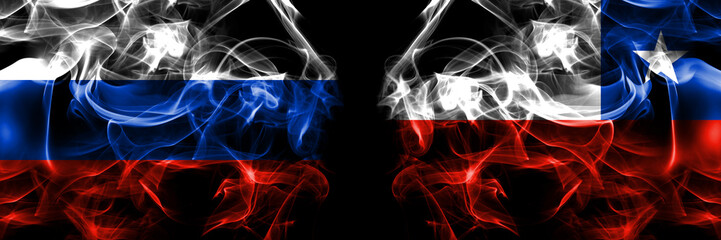Russia, Russian vs Chile, Chilean flags. Smoke flag placed side by side isolated on black background