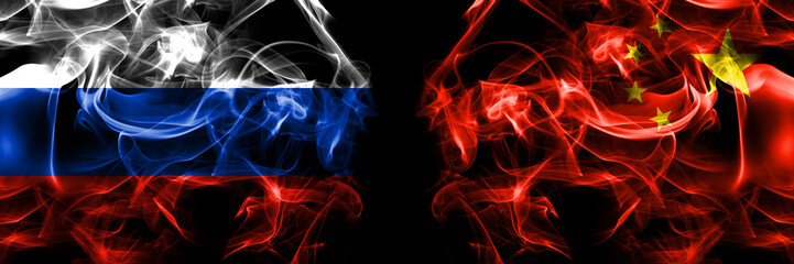 Russia, Russian vs China, Chinese flags. Smoke flag placed side by side isolated on black background