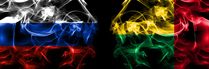 Russia, Russian vs Guinea Bissau flags. Smoke flag placed side by side isolated on black background