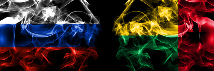 Obraz premium Russia, Russian vs Guinea Bissau flags. Smoke flag placed side by side isolated on black background