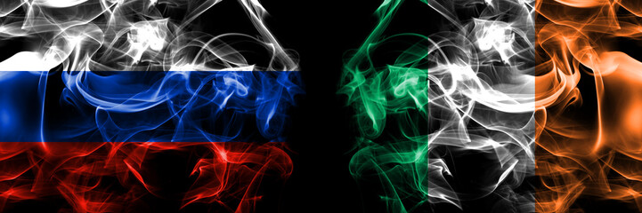 Obraz premium Russia, Russian vs Ireland, Irish flags. Smoke flag placed side by side isolated on black background