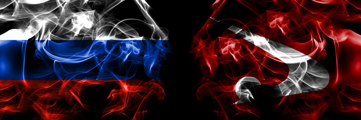 Russia, Russian vs Japan, Japanese, Akita Prefecture flags. Smoke flag placed side by side isolated on black background