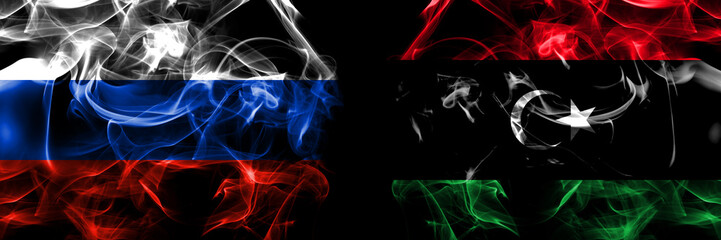 Russia, Russian vs Libya, Libyan flags. Smoke flag placed side by side isolated on black background