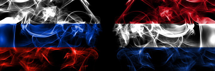 Russia, Russian vs Netherlands, Dutch, Holland flags. Smoke flag placed side by side isolated on black background