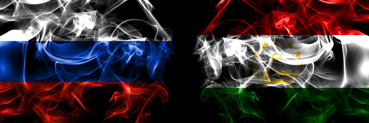 Russia, Russian vs Tajikistan flags. Smoke flag placed side by side isolated on black background