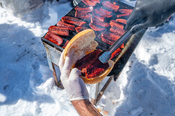 barbecue of  Turkish sucuk which tastes like highly spiced aged crumbled beef that is saturated with fat on outdoor activity.