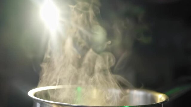 White smoke and steam effect from hot pot on black background