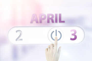 April 3rd. Day 3 of month, Calendar date.Hand finger switches pointing calendar date on sunlight office background. Spring month, day of the year concept.