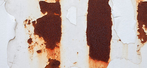 The paint peeled off the wall by rusting. Old wall surface with deceiving color.