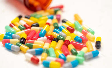 colorful capsule pills and bottle