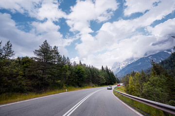 Asphalt road in Alps mountains. Trip concept.