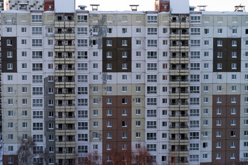 Windows and balconies of the residential building. Old urban obsolete facade of panel house. The...