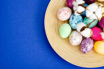 Decorated handmade Easter eggs for the holiday season on blue background. Creative minimal abstract concept. Studio Photo