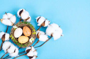 Obraz na płótnie Canvas Top view of color easter haqndmade eggs and nest flatlay. Trendy minimal design spring background. Space for text. Stuio Photo