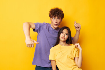 Obraz premium portrait of a man and a woman casual clothes posing emotions antics yellow background unaltered