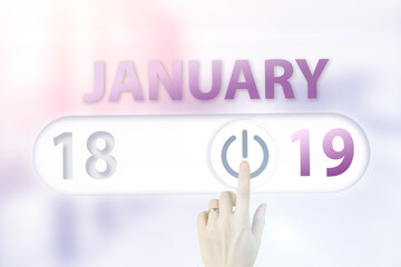 January 19th. Day 19 of month, Calendar date.Hand finger switches pointing calendar date on sunlight office background. Winter month, day of the year concept.