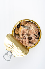Open metal can with canned fish in its own juice. Studio Photo