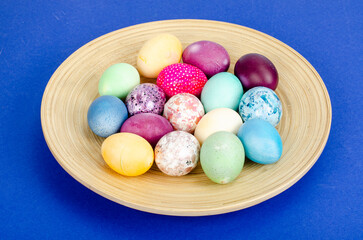 Decorated handmade Easter eggs for the holiday season on blue background. Creative minimal abstract concept. Studio Photo
