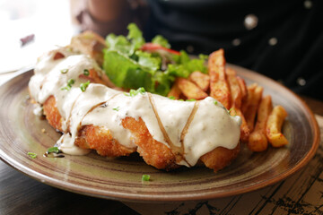 close up of chicken stripe and sauce on table 