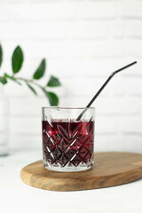 cold cherry drink in a glass on the wooden