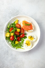balanced breakfast with fish sandwich, boiled egg and vegetables