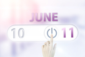 June 11st . Day 11 of month, Calendar date.Hand finger switches pointing calendar date on sunlight office background. Summer month, day of the year concept.