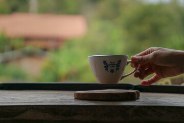 Hand holding cup of coffee.drinking coffee.