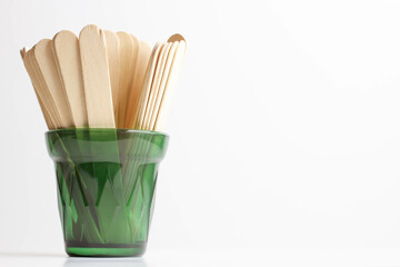 Wooden spatula. Wax spatula for depilation. Shugaring with sugar paste. - obrazy, fototapety, plakaty