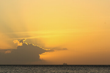 A view of the sea at the orange sunset in Glitter Bay, Barbados, Caribbean